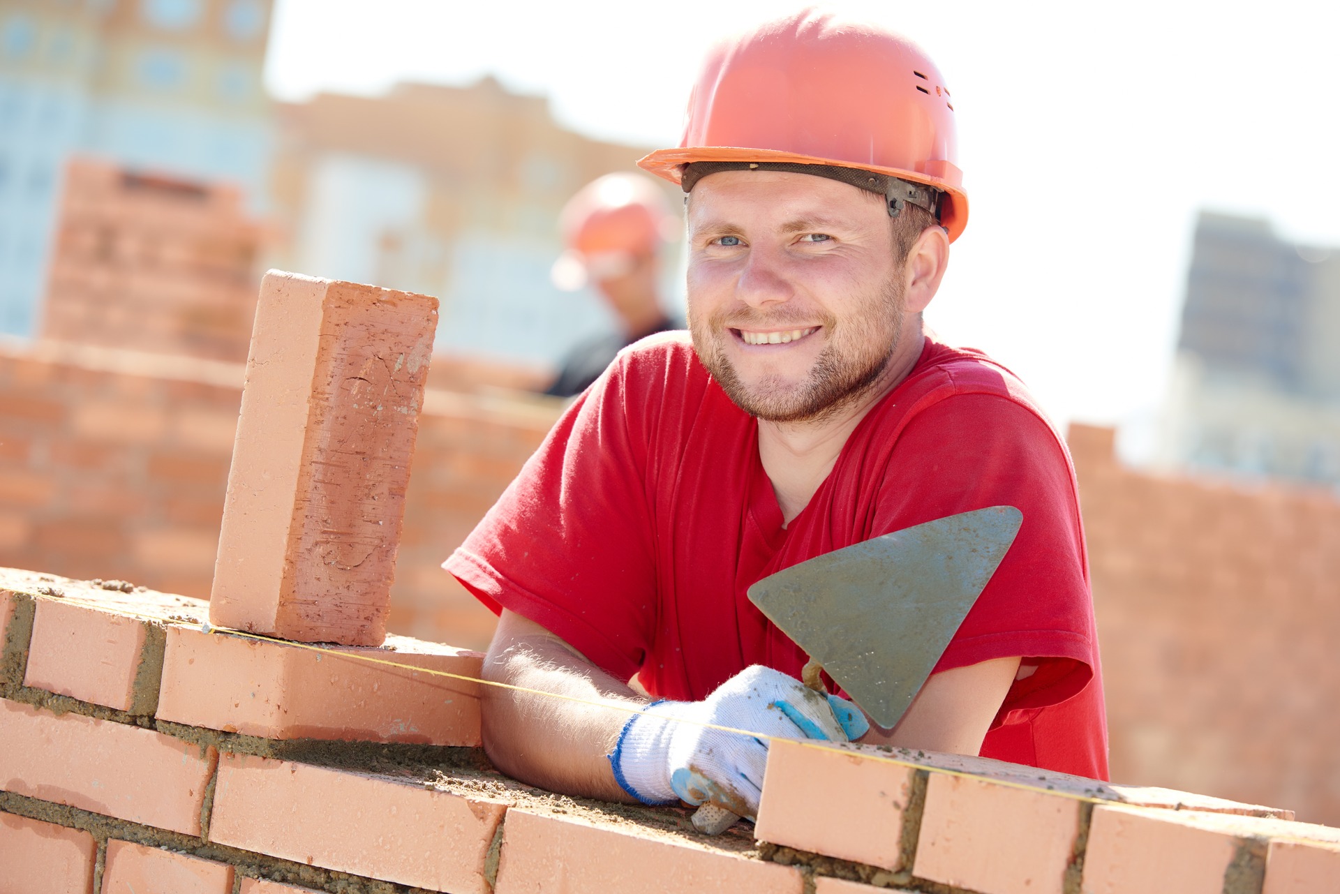 Union bricklayer building a wall